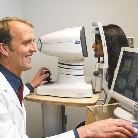 Ames LASIK specialist, Dr. Louis Scallon, performs cornea topography test during LASIK consultation at Wolfe Eye Clinic.