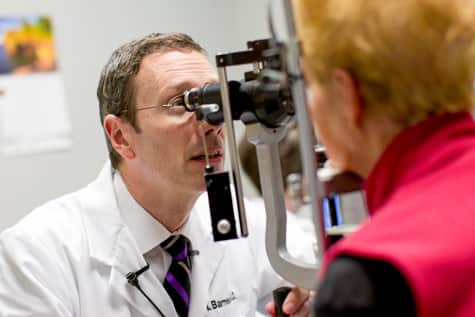 Iowa macular hole retina specialist, Dr. Charles Barnes, examines eyes of patient who may have a macular hole in the retina. 