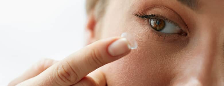 Woman putting in contact lenses in Iowa