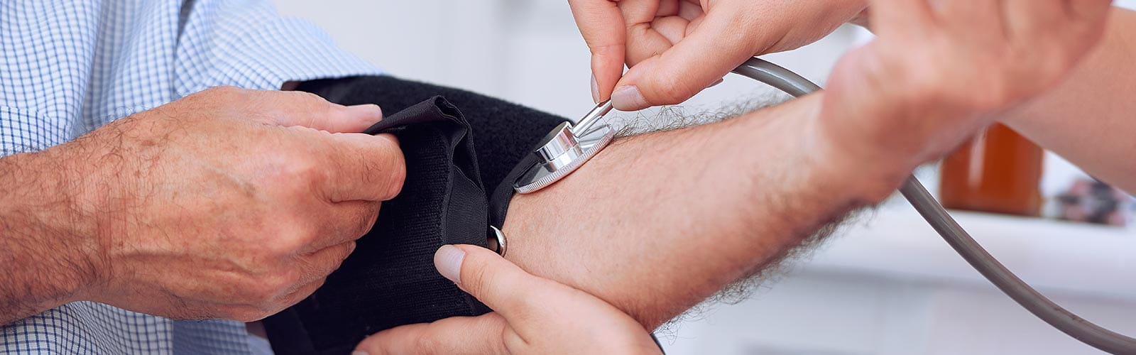 Doctor taking patient's blood pressure