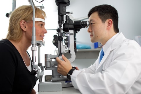 Eye exam during cataract evaluation in Iowa by Wolfe Eye Clinic cataract surgeon, Dr. Peter Rhee, in Cedar Rapids, Iowa.