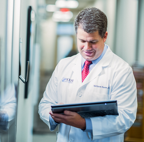 Iowa cornea transplant doctor, Dr. Matthew Rauen, examines cornea exam to determine corneal transplant treatment plan.