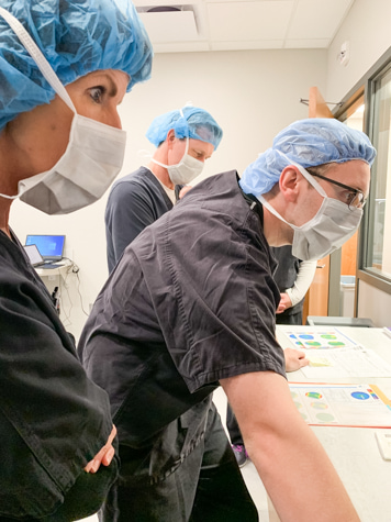 Iowa keratoconus doctor, Dr. Reid Turner, examines patient cornea topography for keratoconus treatment. 