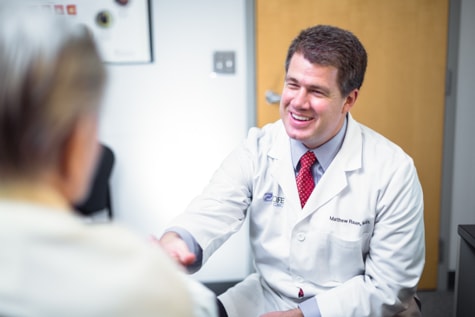 Wolfe Eye Clinic refractive specialist, Dr. Matthew Rauen meets with patient during LASIK evaluation in Fort Dodge, Iowa.