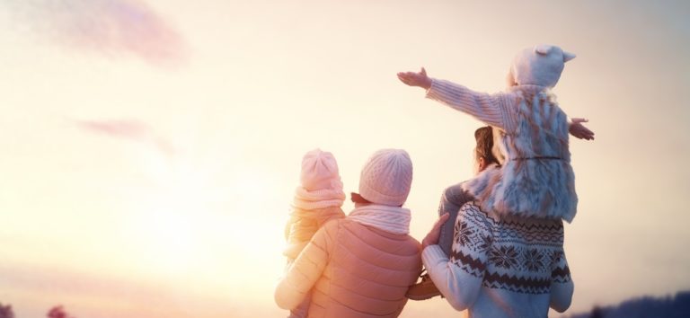 Happy family protecting eyes from Iowa winter weather.