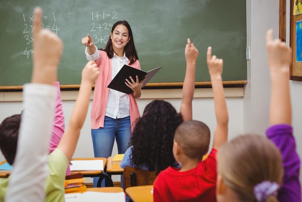 Iowa teacher considering LASIK eye surgery in classroom.